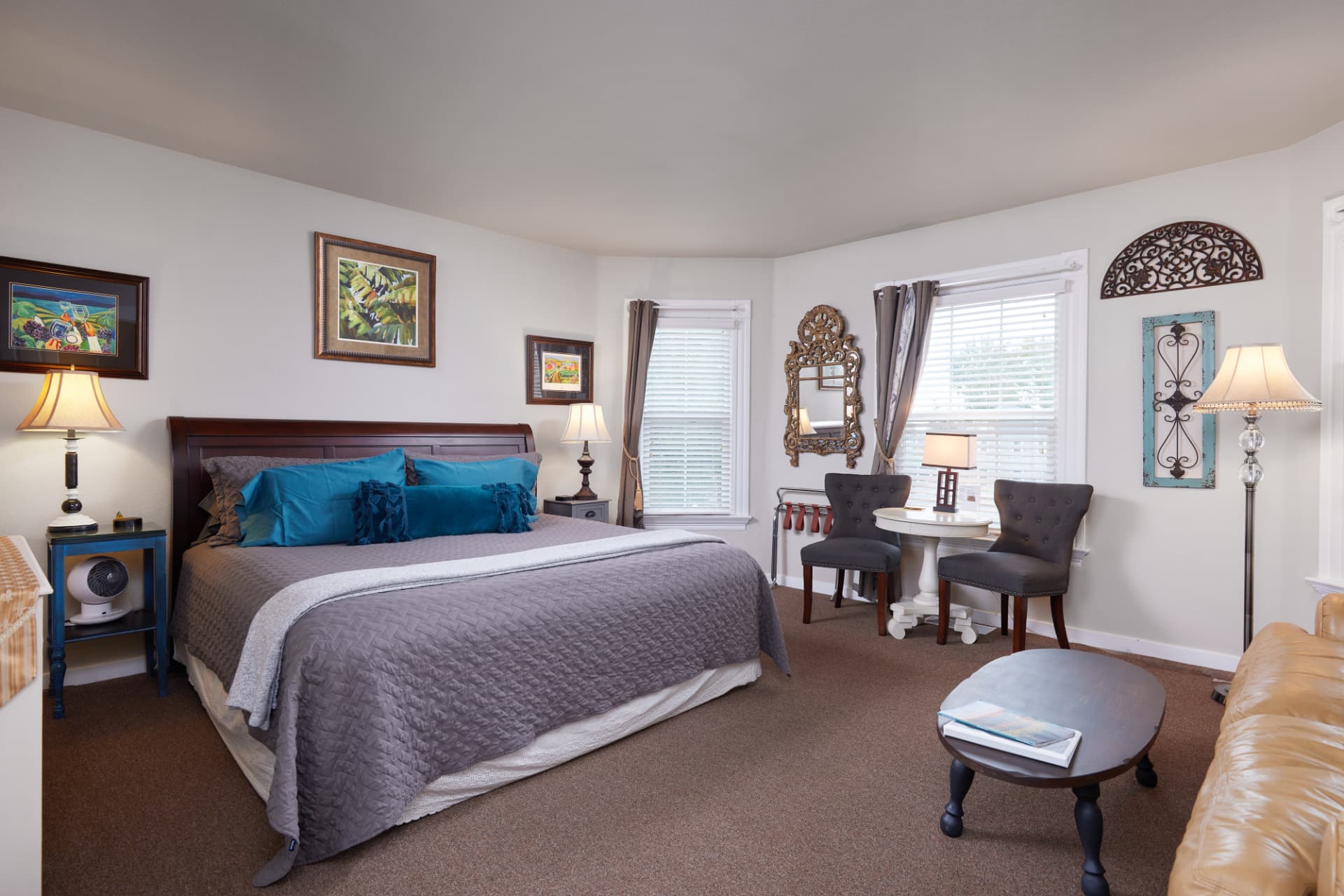 The Vineyard king bedroom with two grey armchairs and a small table